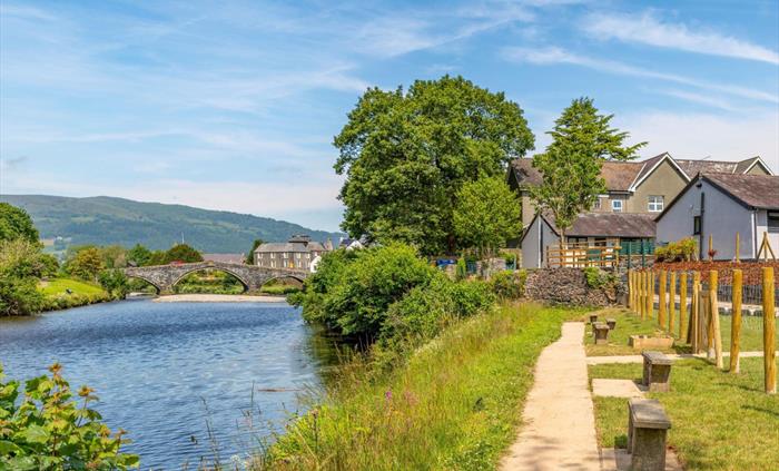 River pathway with view of Llanrwst's stone bridge